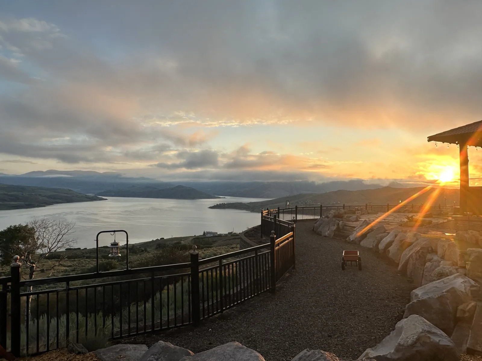 A vivid sunset over the reservoir and surrounding hills